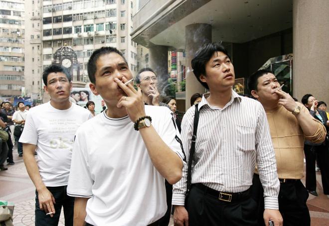 A group of men enjoy a smoke as they joi