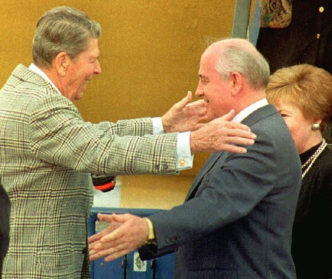 Former U.S. President Ronald Reagan (L) greets for