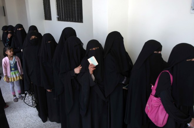 Yemeni women line-up outside a polling s