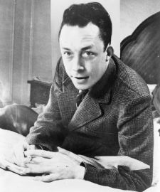640px-Albert_Camus,_gagnant_de_prix_Nobel,_portrait_en_buste,_posé_au_bureau,_faisant_face_à_gauche,_cigarette_de_tabagisme