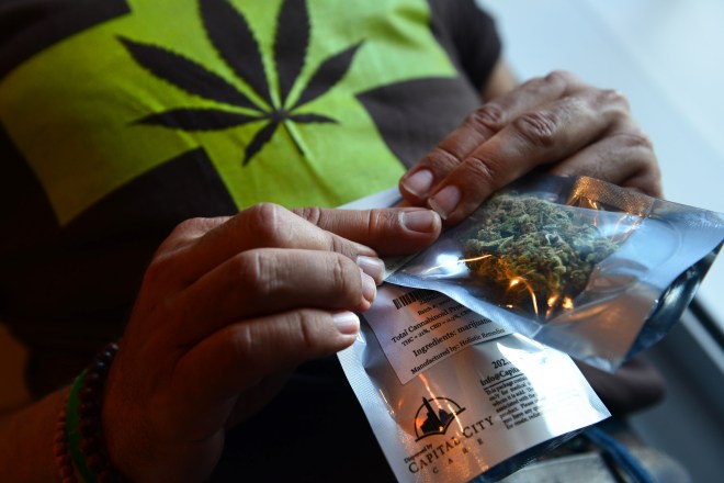 WASHINGTON, DC - JULY 29:   A man purchases medical marijuana,